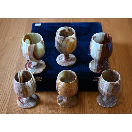 483 - A cased set of six turned onyx goblets