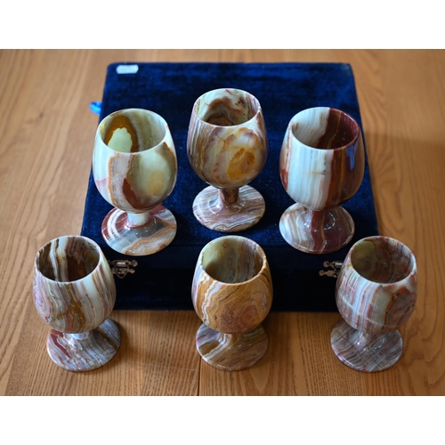 483 - A cased set of six turned onyx goblets