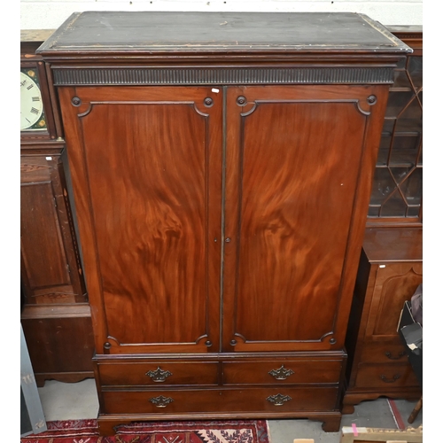 53 - A 19th century mahogany wardrobe with moulded pediment over two doors enclosing hanging space, the b... 