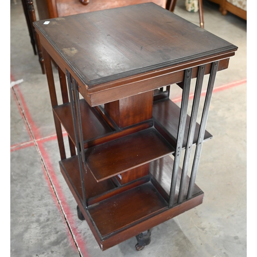 65 - Edwardian mahogany square revolving bookcase on cruciform base with casters, 45 x 45 x 84 cm high