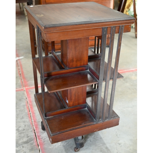 65 - Edwardian mahogany square revolving bookcase on cruciform base with casters, 45 x 45 x 84 cm high