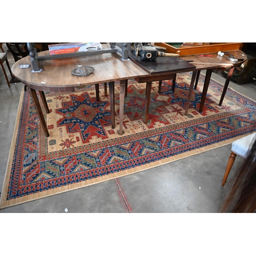 70 - An Egyptian made 'Arabella' carpet, red and blue geometric design on camel ground, 330 x 240 cm