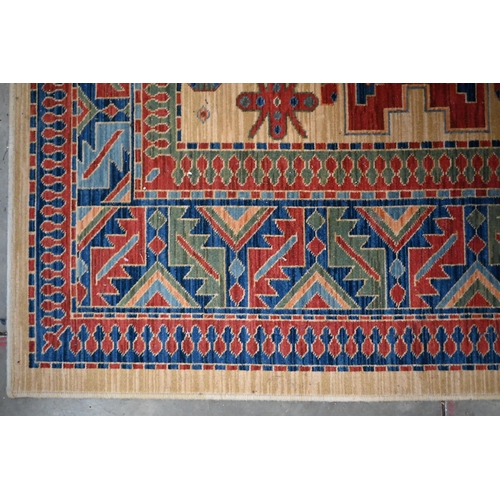 70 - An Egyptian made 'Arabella' carpet, red and blue geometric design on camel ground, 330 x 240 cm