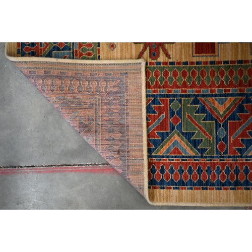 70 - An Egyptian made 'Arabella' carpet, red and blue geometric design on camel ground, 330 x 240 cm