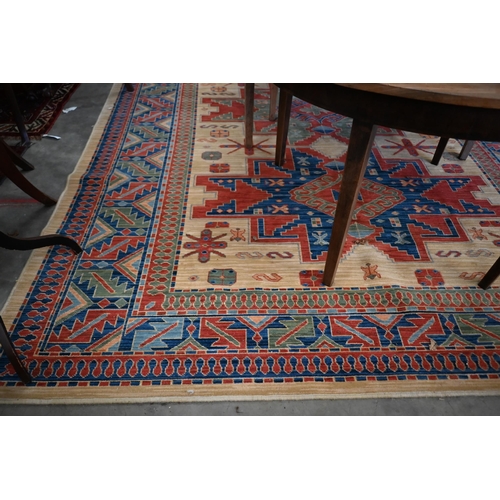 70 - An Egyptian made 'Arabella' carpet, red and blue geometric design on camel ground, 330 x 240 cm