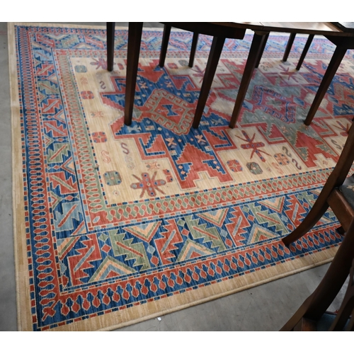 70 - An Egyptian made 'Arabella' carpet, red and blue geometric design on camel ground, 330 x 240 cm