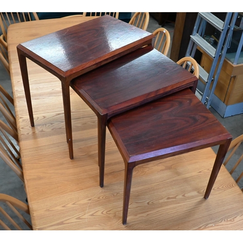 71 - A nest of three mid-century rosewood tables, the largest 60 cm wide x 36 x 50 cm high