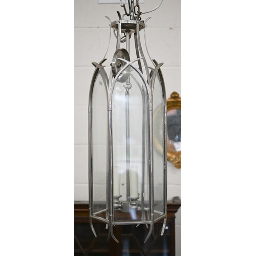 86 - A large Gothic-style three light pendant lantern, with six lancet glass panels and suspension chain,... 