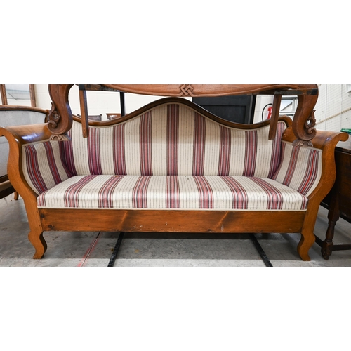 89 - A 19th century Continental Biedermier sofa with shaped back and scroll arms upholstered with striped... 