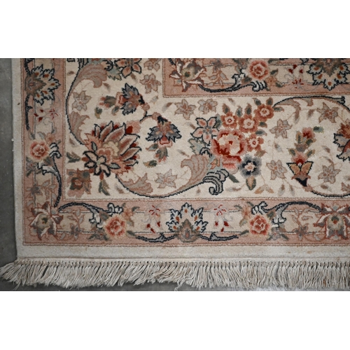 91 - A Chinese cream ground carpet with traditional Persian sylised floral design, 356 x 256 cm (treated ... 