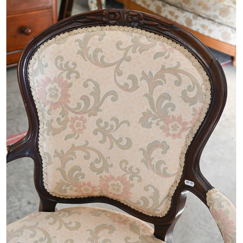 95 - A French Louis XV style fauteuil armchair with foliate upholstery