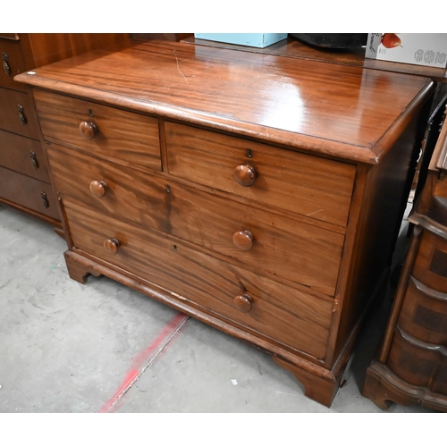 97 - A 19th century mahogany low chest of two short over two long drawers with turned handles, raised on ... 