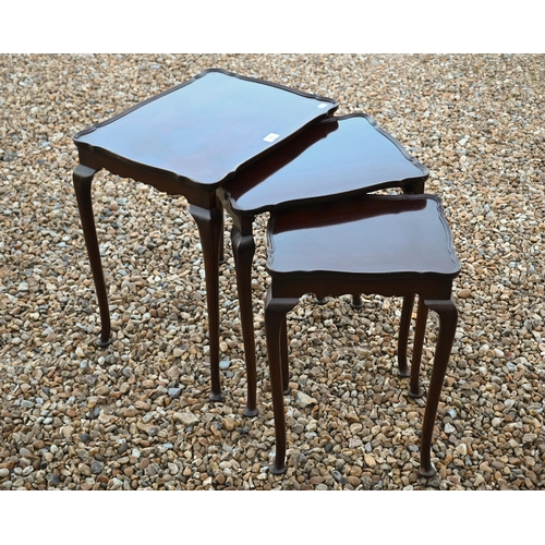 538 - A nest of three mahogany tables on cabriole legs with pad feet