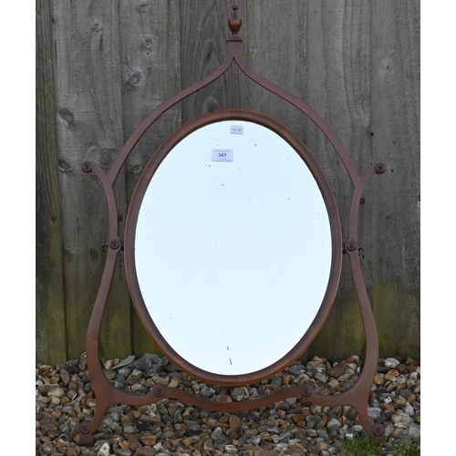 547 - An oval dressing table mirror on scrolling slim-line frame with turned finial, 76 cm high