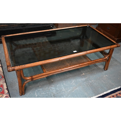 552 - A KOK (Maison) French bamboo and rattan coffee table, with smoked glass top, 138 cm x 70 cm x 40 cm ... 