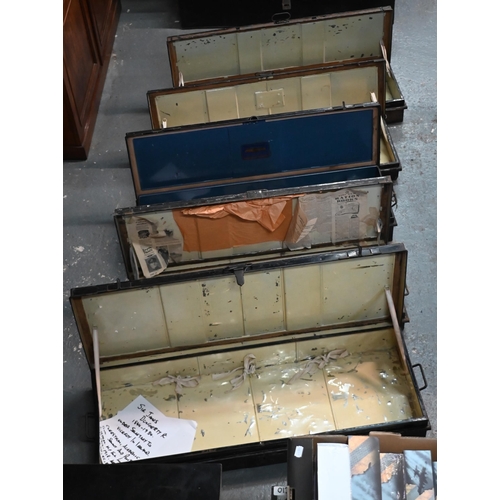 557 - A stack of five antique and later japanned steel military uniform/transit trunks, variously labelled... 