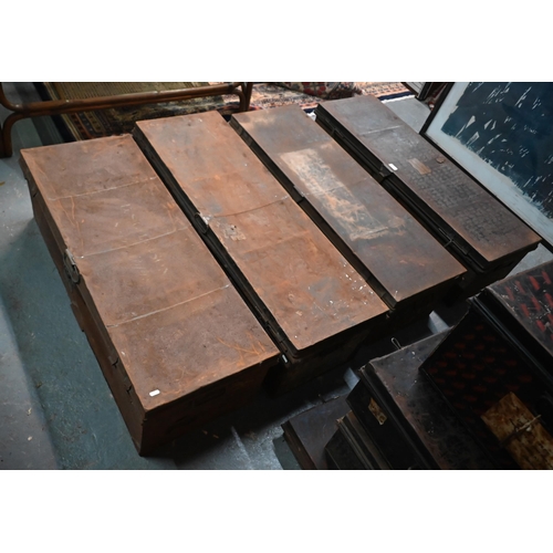 562 - A stack of four assorted japanned steel military uniform trunks, variously labelled incl. J. Roberts... 