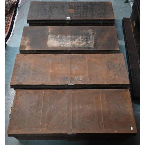 562 - A stack of four assorted japanned steel military uniform trunks, variously labelled incl. J. Roberts... 