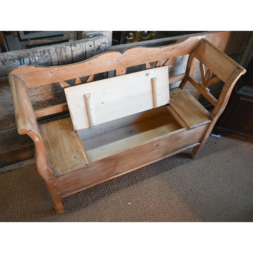 192 - A Continental stropped pine box seated settle/hall bench, 127 cm w x 42 cm x 90 cm h