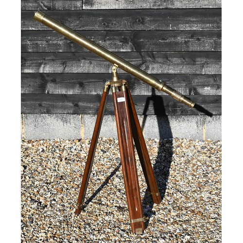 358 - A reproduction brass telescope, 100 cm long, on adjustable wooden tripod