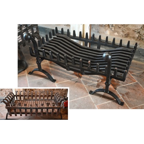 235 - A contemporary traditional cast iron fire basket and dogs to/with another weathered example in the 1... 