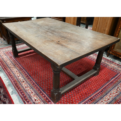 919 - An antique oak refectory table, the wide four plank top over a plain frieze and joint frame with tur... 