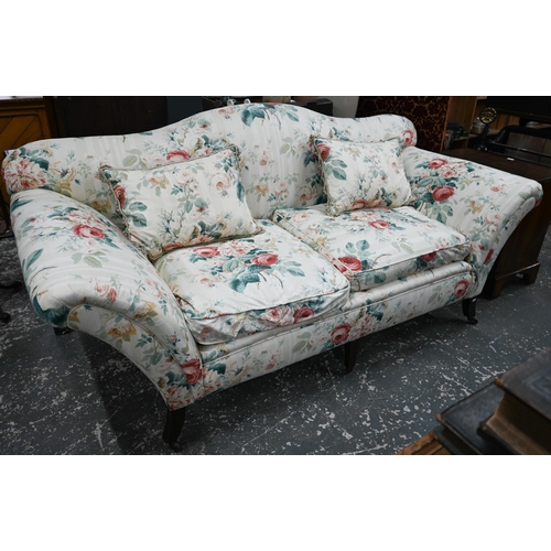 916 - A Georgian style hump back scroll arm sofa, in floral Colefax & Fowler fabric, raised on three f... 