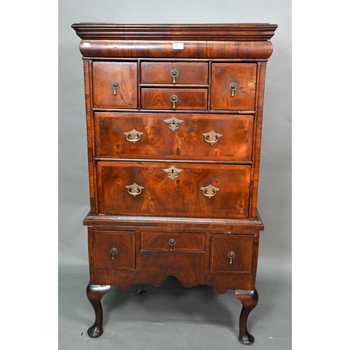 920 - A Queen Anne period and later altered feather banded walnut chest on stand, the moulded cornice over... 