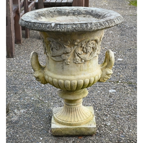 A large pair of weathered cast stone campagna urns, 80 cm h, one with detached handle, present