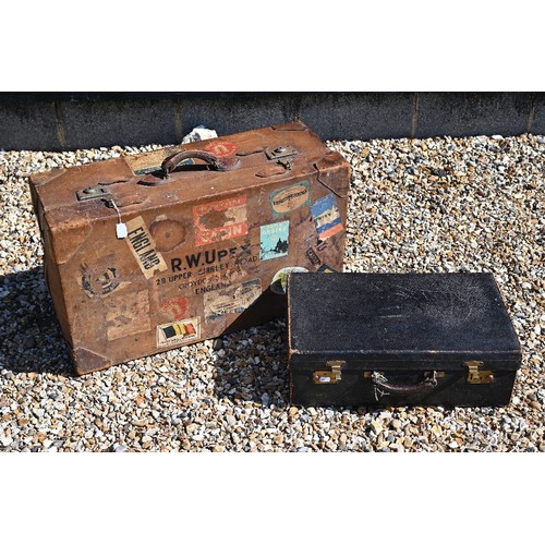 520 - A large vintage leather suitcase with various labels including Cunard White Star First Class and var... 