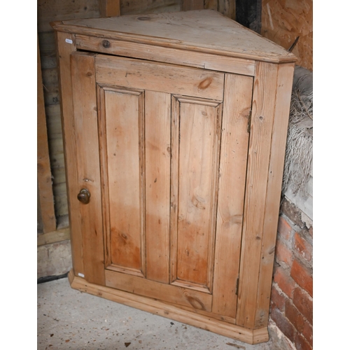 103 - A Victorian stripped pine hanging corner cupboard