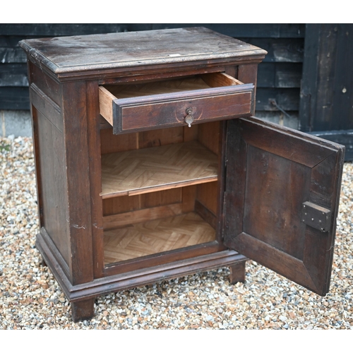 108 - An 18th century Italian walnut side cabinet, with frieze drawer over a mitre framed door, raised on ... 