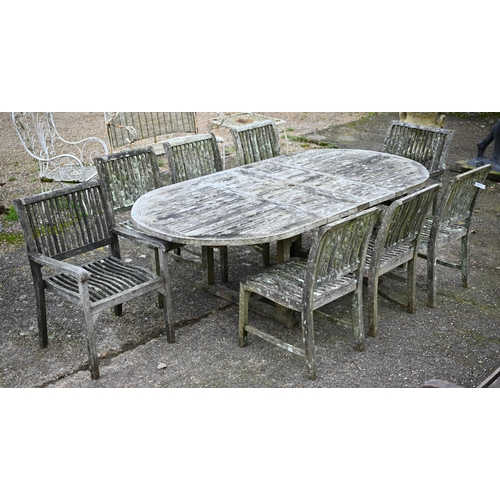 A large weathered 'Teak Unique' garden set comprising an extendable dining table, six side chairs and pair of carver chairs, a/f