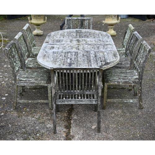 111 - A large weathered 'Teak Unique' garden set comprising an extendable dining table, six side chairs an... 