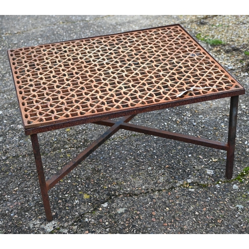 112 - A weathered cast iron 'grate' coffee table within a steel frame raised on cross stretchers to/w a pa... 