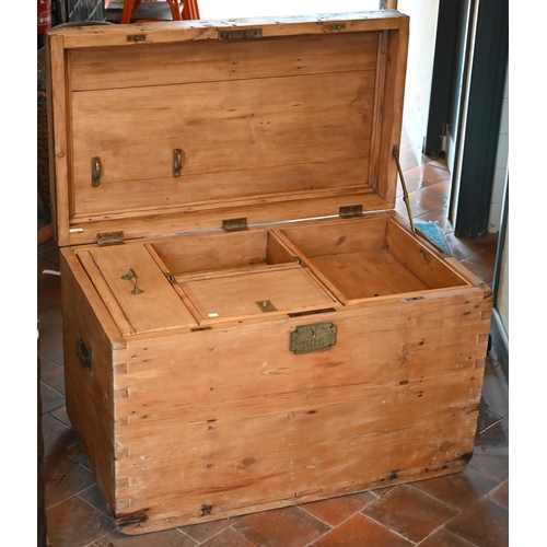 120 - An early 20th century large pine carpenter's tool chest with hinged top enclosing the compartmentali... 