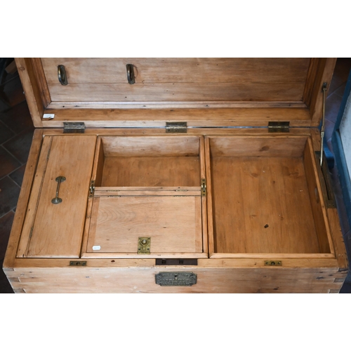 120 - An early 20th century large pine carpenter's tool chest with hinged top enclosing the compartmentali... 