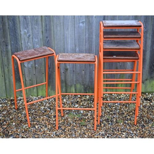 122 - Six vintage stacking school laboratory stools with hardwood seats and orange metal tubular frames