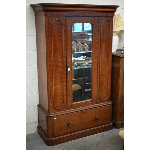 141 - A Victorian mahogany wardrobe with mirrored door enclosing hanging rail on single drawer base, 130 x...