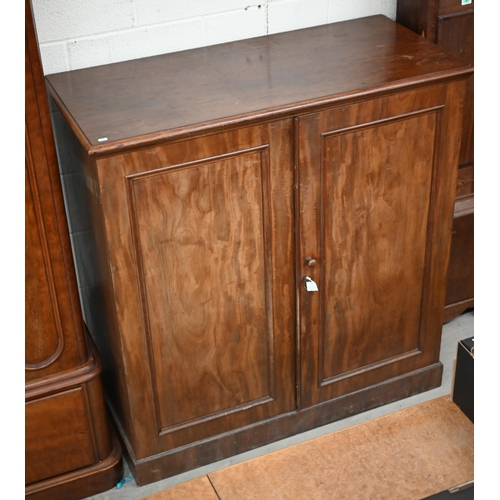 142 - A 19th century mahogany linen press cabinet with pair of panelled doors enclosing four slides, stamp... 