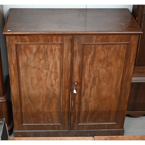 142 - A 19th century mahogany linen press cabinet with pair of panelled doors enclosing four slides, stamp... 