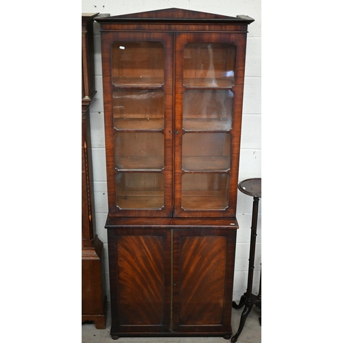 145 - A mid 19th century mahogany bookcase cabinet with two door glazed top on two door cabinet base with ... 