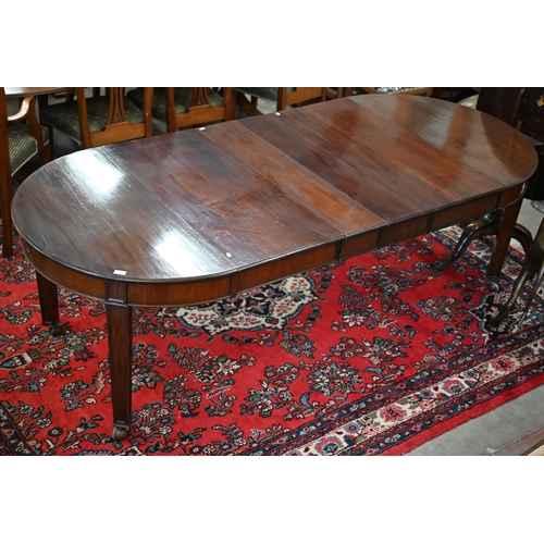 182 - An early 20th century mahogany extending wind-out action dining table, the rounded top with four lea... 