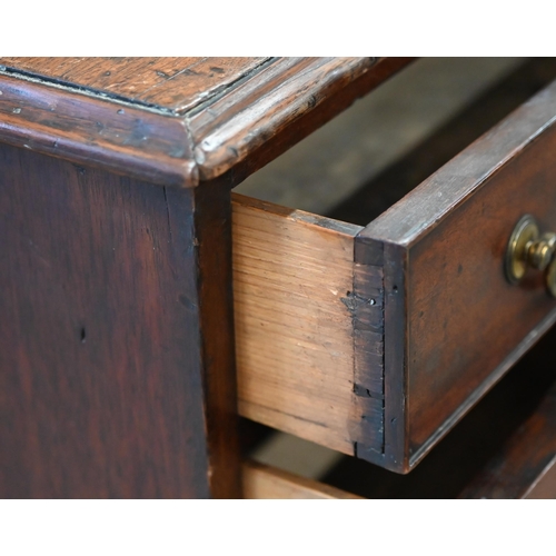 185 - A Georgian mahogany kneehole desk with recessed central cupboard and arrangement of seven drawers on... 