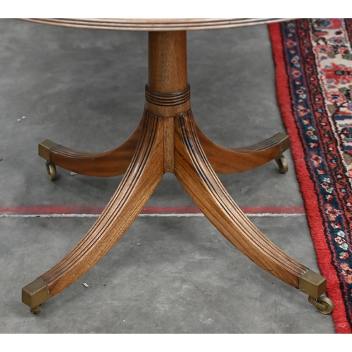 186 - A Regency style mahogany extending dining table with two central leaves on twin-pedestals and splaye... 