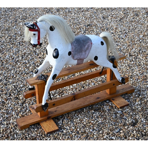 190 - A vintage dapple-painted wooden rocking horse on pine base, 106 cm wide x 84 cm high