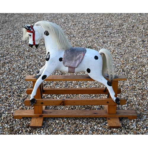 190 - A vintage dapple-painted wooden rocking horse on pine base, 106 cm wide x 84 cm high