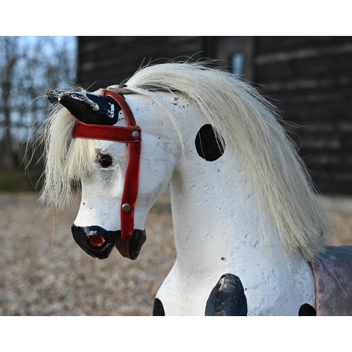 190 - A vintage dapple-painted wooden rocking horse on pine base, 106 cm wide x 84 cm high