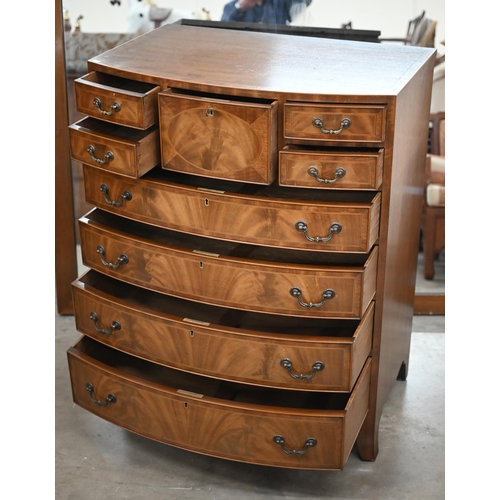 196 - A reproduction mahogany bowfront tall boy chest with an arrangement of nine drawers on splayed feet,... 