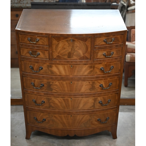 196 - A reproduction mahogany bowfront tall boy chest with an arrangement of nine drawers on splayed feet,... 